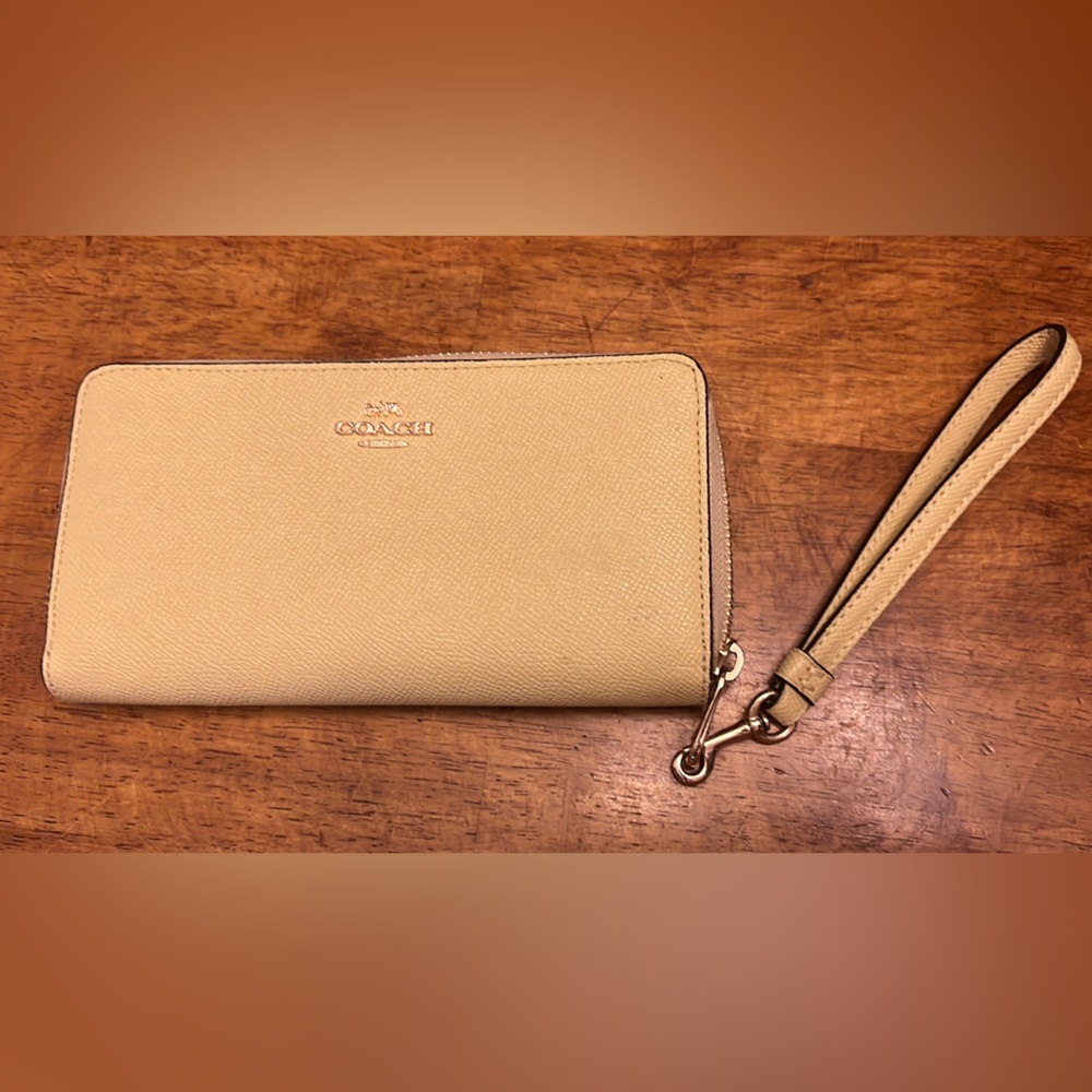 Coach wallet. iPhone 13 fits inside.